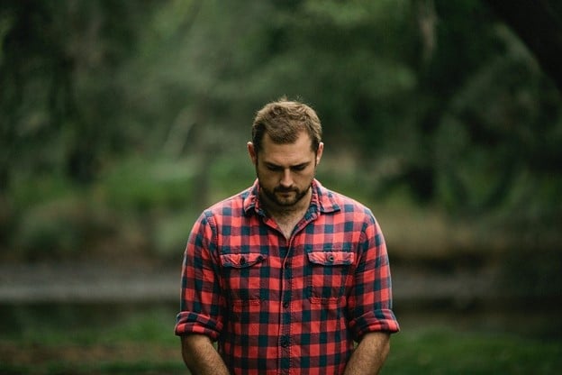 man wearing a flannel shirt outdoors