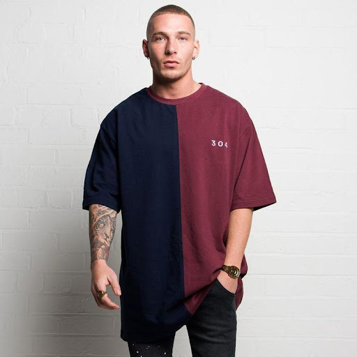 A-guy-putting-on-dual-color-oversized-tee