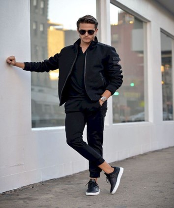 A-man-rocking-a-black-bomber-jacket-with-sneakers 