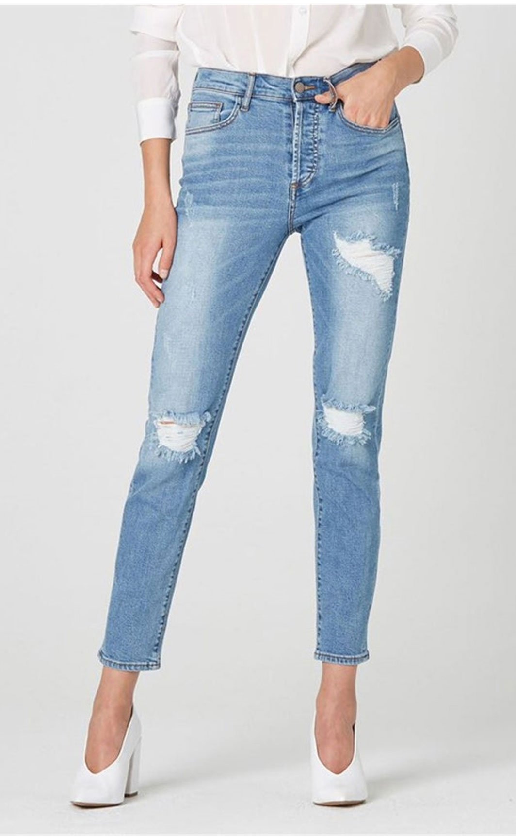 women wearing distressed denim jeans
