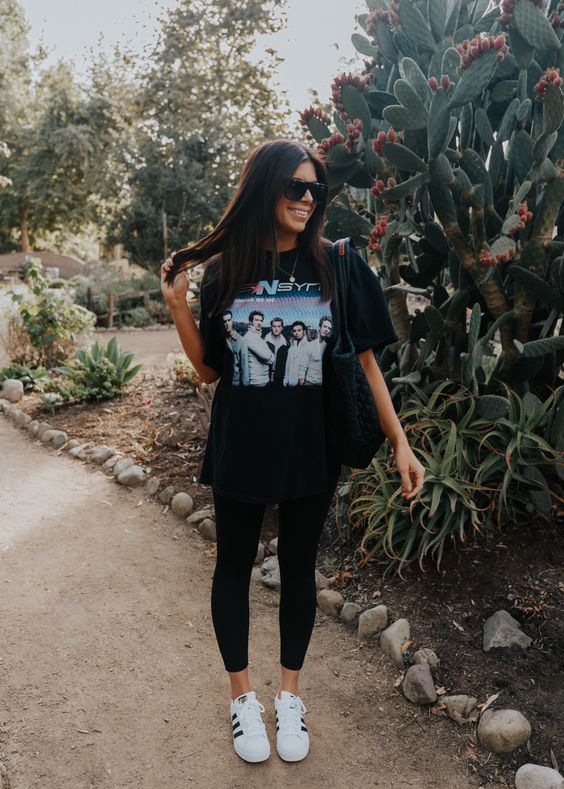 lady combines Oversized graphic tee with leggings