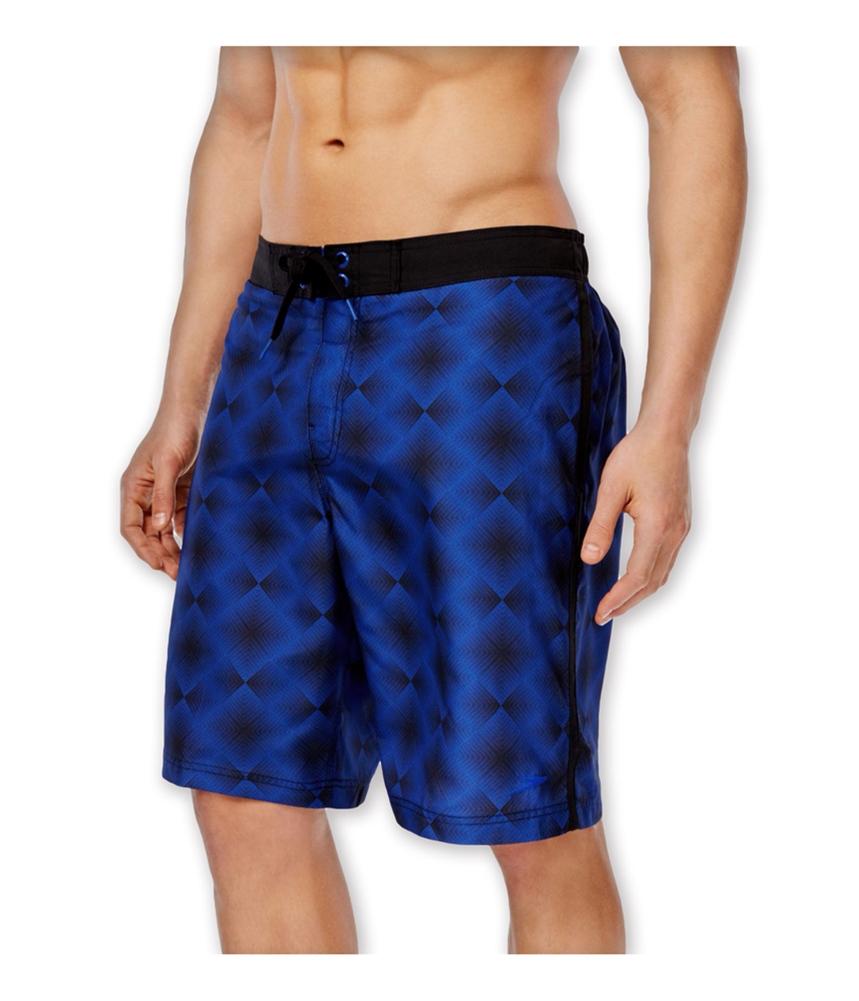 Man-wearing-blue-geometric-print-board-shorts