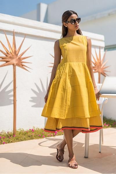 lady models in yellow sleeveless dress