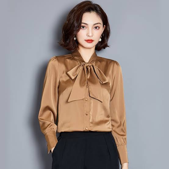 lady models in brown tie-neck blouse the old-fashioned way