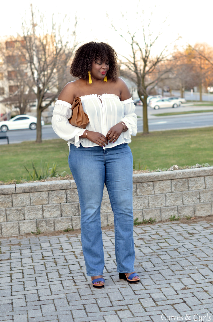 lady models in white off-the-shoulder blouse and wide leg jeans